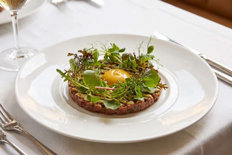 Rindstatar mit Eigelb und frischen Kräutern als Vorspeise in der Brasserie RitzCoffier am Bürgenstock, Gourmet-Restaurant über dem Vierwaldstättersee, Restaurant-Transfer ab Zürich mit Chauffeur