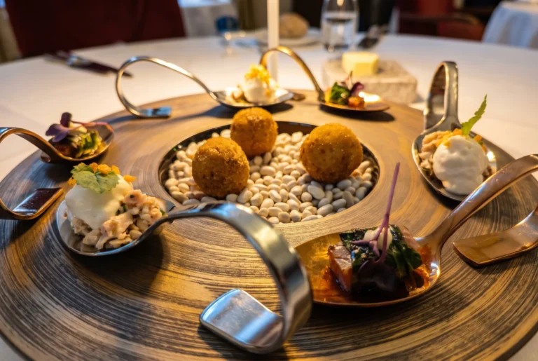 Feine Amuse-Bouche auf Design-Löffeln mit Kroketten und weissen Bohnen im Schloss Bottmingen, Gourmet-Restaurant bei Basel, Restaurant-Transfer ab Zürich mit Chauffeur